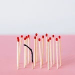 Picture of a group of matches with one burned out